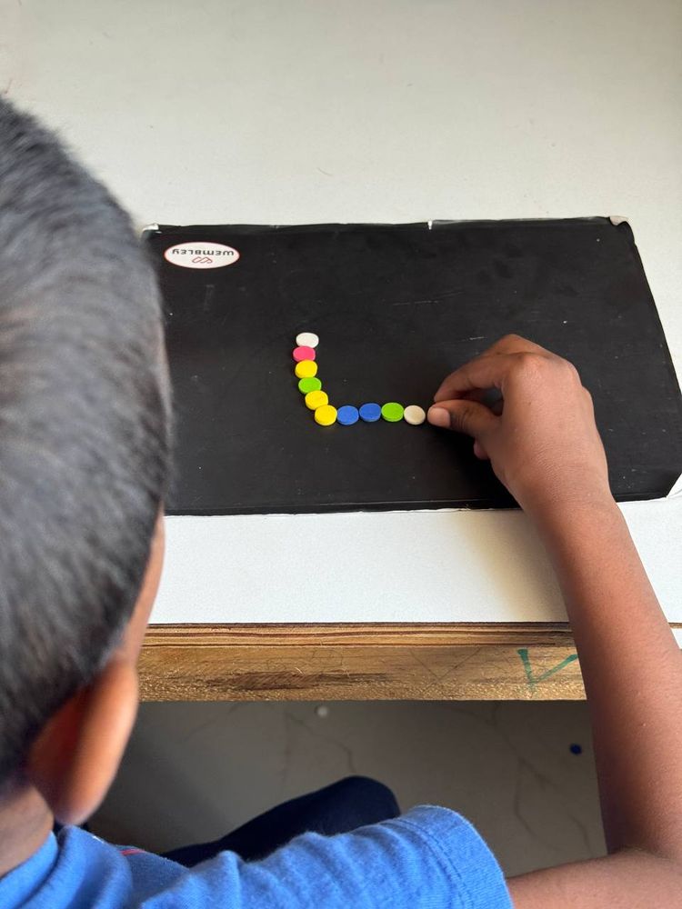 Child working on a colour and pattern matching board